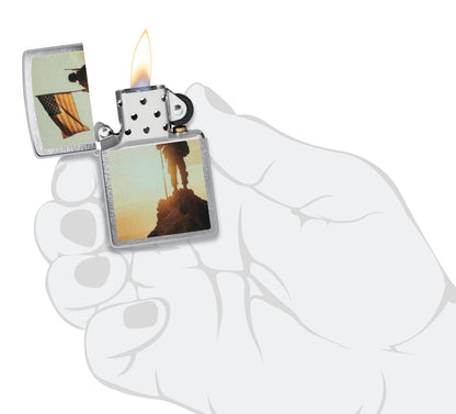 Zippo Soldier and Flag Design Brushed Chrome Windproof Lighter  lit in hand.