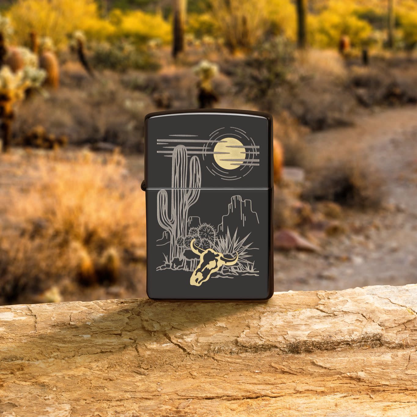Lifestyle image of Zippo Western Design High Polish Black Windproof Lighter on a rock with a desert background.