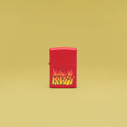 Lifestyle image of Zippo KISS Design Red Matte Windproof Lighter standing in a yellow scene.